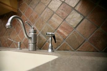 Inexpensive tiles are one idea for a frugal backsplash..