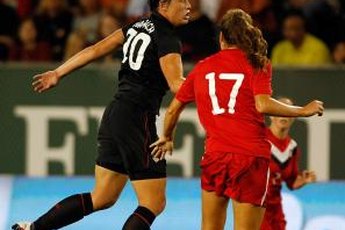 Abby Wambach heads the ball against Canada.