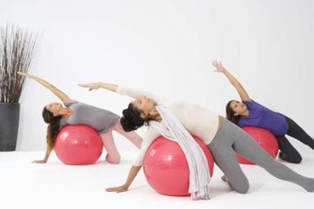 Exercise balls, both large and small, can help you strengthen your abs, hips and thighs.