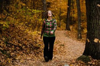Hiking on a natural surface trail in the woods can offer a mental escape.
