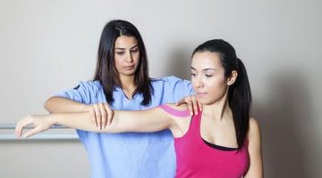 A physical therapist is working with her patient.