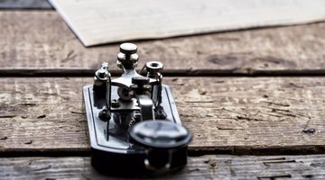 An old telegraph machine on a wood table.