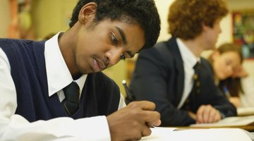 Student in school uniform working at desk.