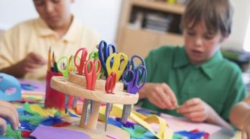 Kids in art class making paper bookmarks