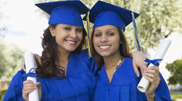 Smiling doctorate graduates in cap and gowns.
