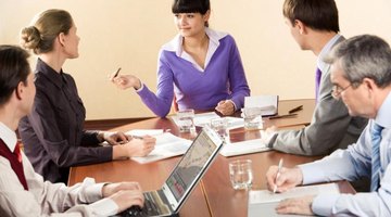 Teachers talking at round table.