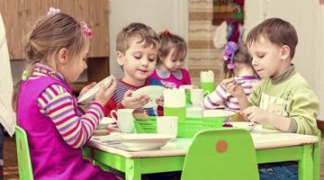 A group of young kindergartners building towers.