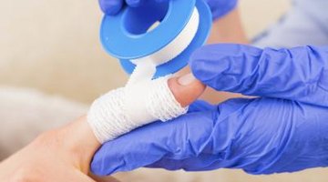 A nurse putting on a band-aid.