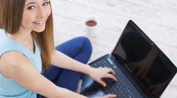Teenager using laptop computer