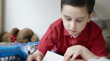 Young student reading book.