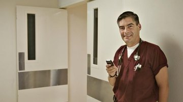 Veteran nurse holding cellphone in hallway