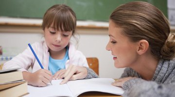 Elementary school teacher working with young student