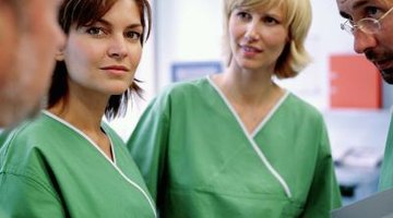 Two female nurses in scrubs.