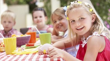 Children having an outdoor tea party.