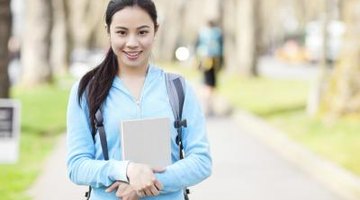 Smiling student walking on college campus