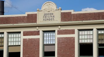 Failing School sign still in place on the roofline of NCNM's main building
