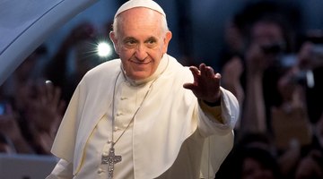 A pope greets a crowd of people.