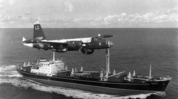 A P2V Neptune U.S. patrol plane flies over a Soviet freighter during the Cuban missile crisis in this 1962 photograph.