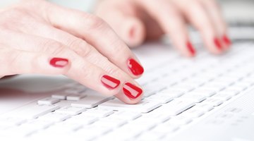 Close-up of hands typing on keyboard