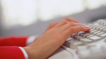 Close-up of woman typing on keyboard.