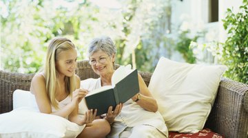 Girl reading with senior woman on couch
