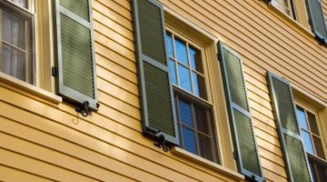 Cape Cod homes have regularly spaced, uniform windows with shutters.