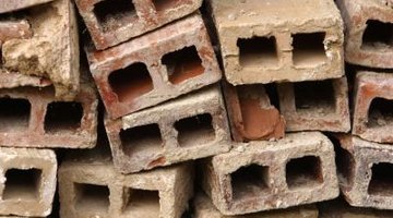 Each cinder block must be placed into the trench with the holes facing the ground.