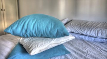 A stack of blue and white pillows on the bed.