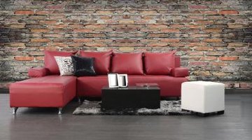 Red leather couch with contrasting block tables and throw pillows.