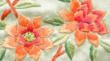 A close-up of pink and peach embroidered flowers.