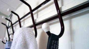 Coat hooks are inexpensive and can be easily screwed into the wall through a snowshoe for a unique look.