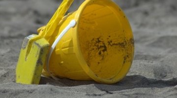 A bucketful of sand is a safe agent to soak up denatured alcohol.