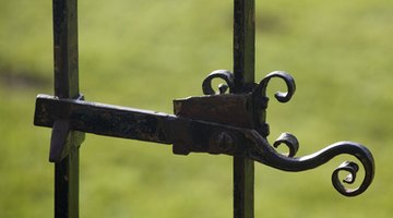 Assuming the gate opens out, tie the rope to the inside of the gate, as the kettlebell will pull the gate shut.