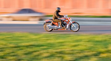 Man riding motorbike on street (blurred motion)