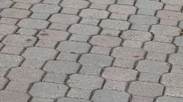 Prepare to remove wax by placing a towel on the pavers.