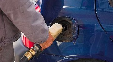 person filling petrol in a car gas tank