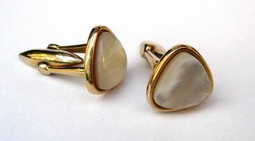Gold cuff links are appropriate favours for guests.
