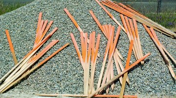 Use wooden stakes to support the concrete form.