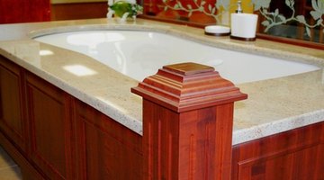 This mahogany-trimmed tub is toned down by its grey stone border.