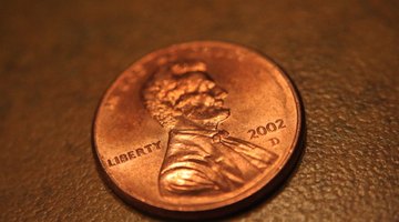 A penny acts as a safe scraping tool to remove dried Wite-Out.