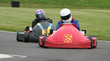 Go-cart racers driving on tire lined track