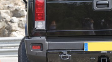 Man driving SUV, mid section, view from back seat