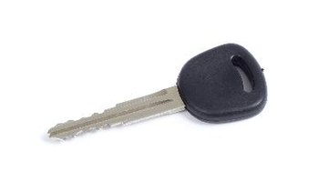 male hand holding car key with new black car in background