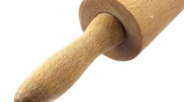A standard kitchen rolling pin works to flatten the clay.