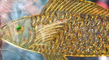 Paint scalloped fish scales with a mixture of white and yellow paint.