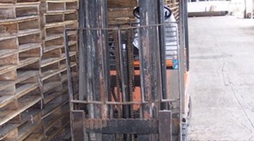 Forklifts are used for stacking pallets in warehouse operations.
