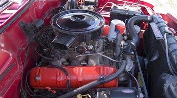 Close-up of mechanic examining bonnet of car