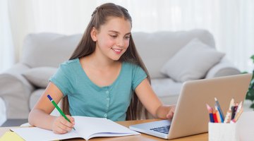 Young girl with headset doing homework on floor