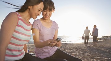 Young woman with cell phone and annoying children