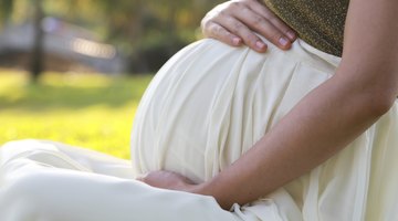 Cropped pregnant woman with blue booties